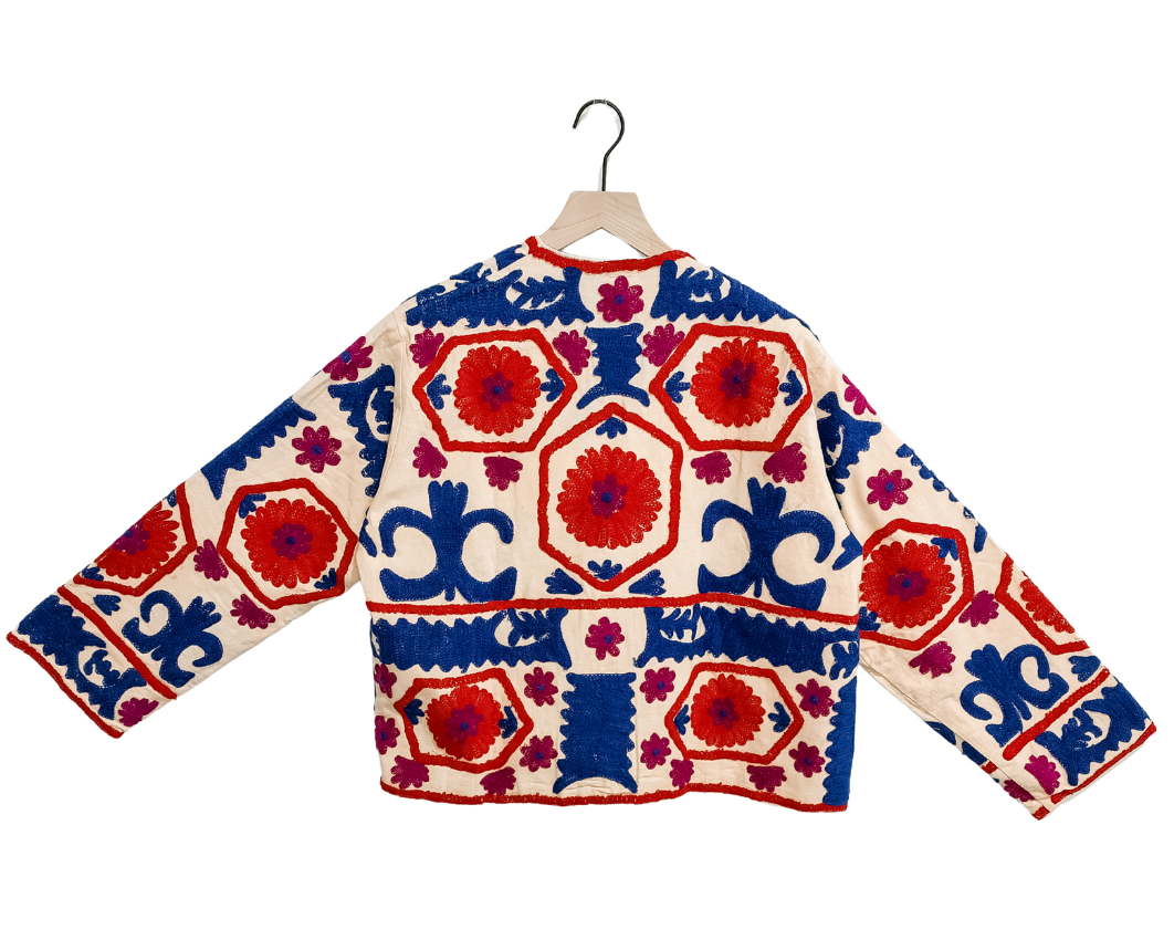 Hand-embroidered cream cropped jacket with red hexagon medallions and blue scrollwork, one-of-a-kind women's western statement jacket by Chap & Graham Designs