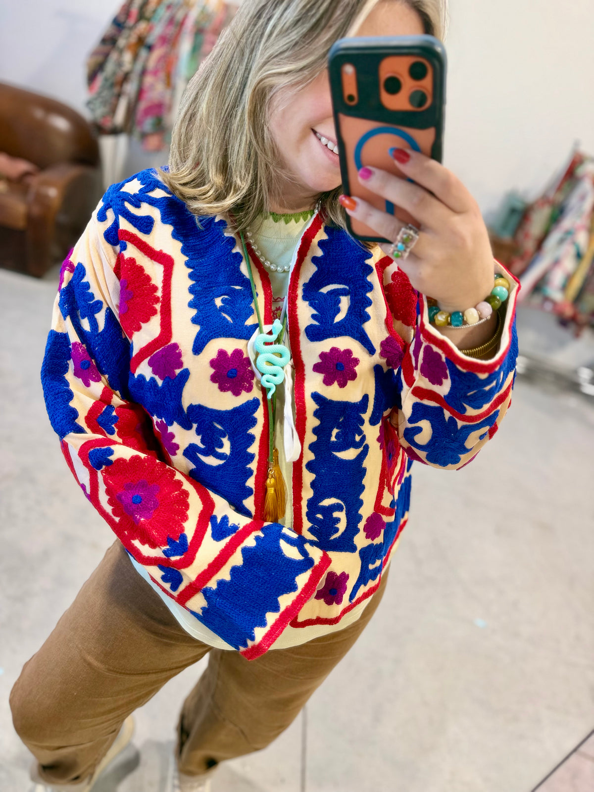 Bloom Medallion Embroidered Jacket on a hanger, boxy one-size women's jacket covered front to back in red, royal blue and magenta embroidery