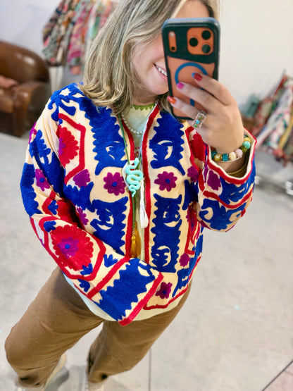 Bloom Medallion Embroidered Jacket on a hanger, boxy one-size women's jacket covered front to back in red, royal blue and magenta embroidery